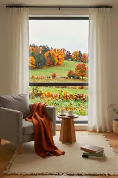 Living Room with Green View and Warm Decor white curtains