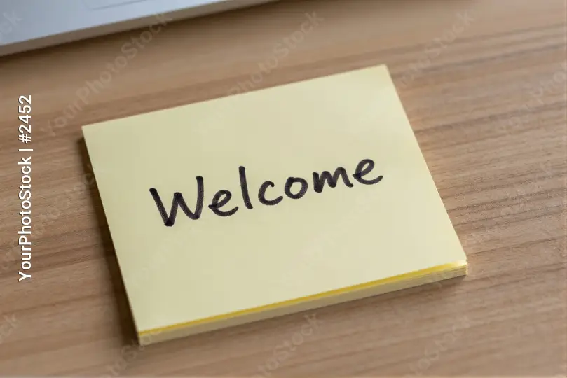 Welcome Note on Wooden Desk sticky laptop office
