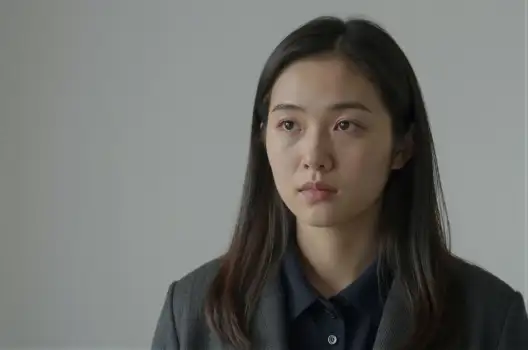 Young Asian Woman in Serious Expression Wearing Dark Blue Blazer