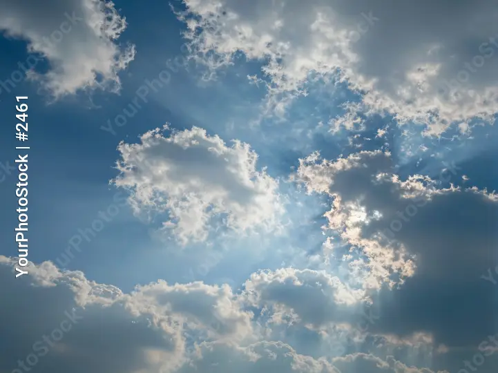 Fluffy Clouds in Deep Blue Sky sunlight warm glow