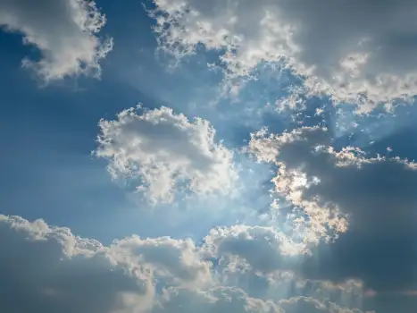 Fluffy Clouds in Deep Blue Sky sunlight warm glow