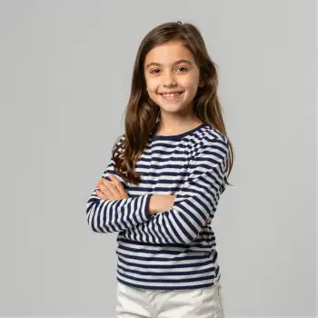 Happy young girl with arms crossed, navy blue and white striped shirt