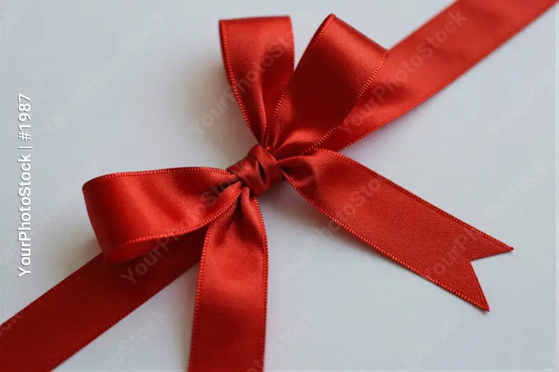 Red Ribbon Bow Close-Up satin texture white background gift