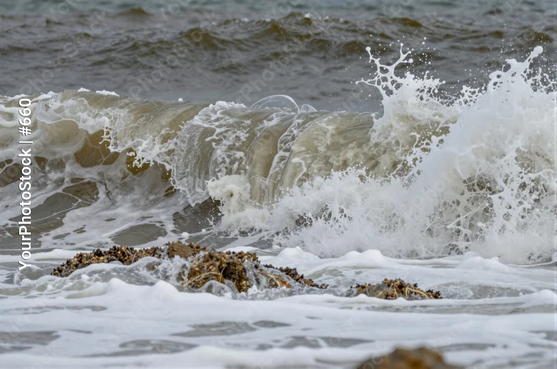 Dramatic Wave Crashing onto Rocky Shore turbulent