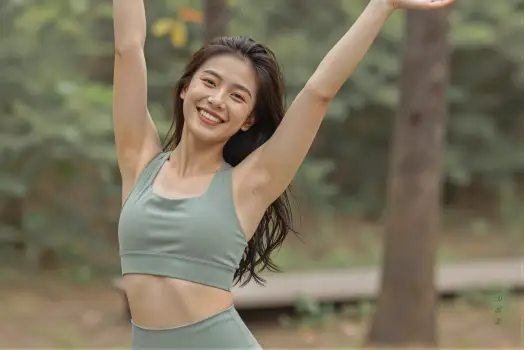 Happy Young Woman Dancing in Park trees smiling fitness sport