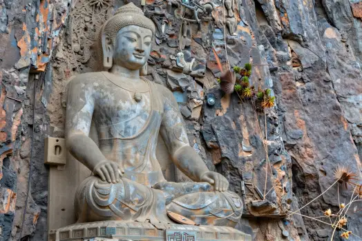 Seated Buddha Statue on Rocky Cliff stone carved
