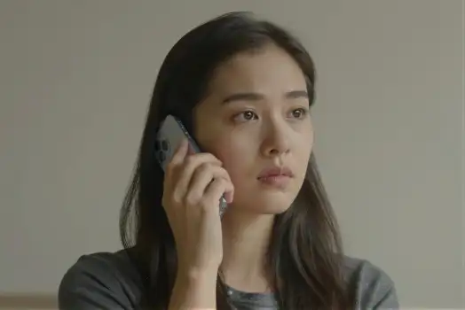 Young Woman Deep in Thought on Phone serious expression