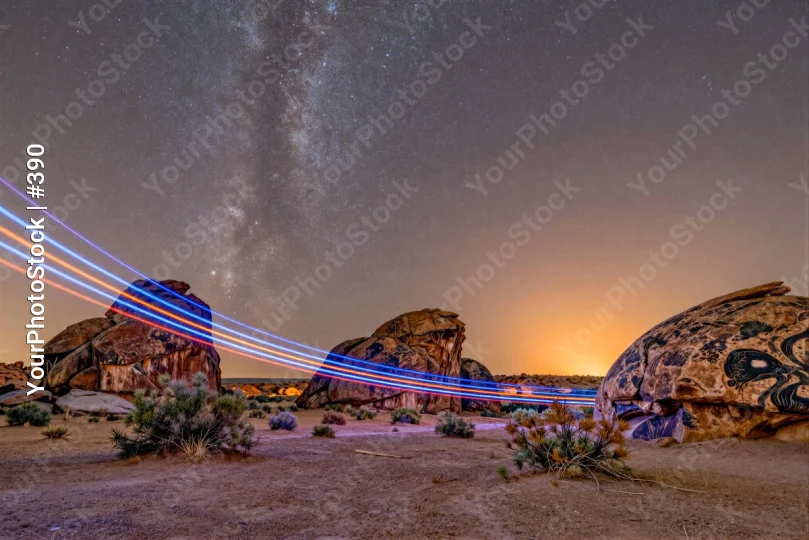 Desert Landscape at Sunset with Milky Way and Light Trails