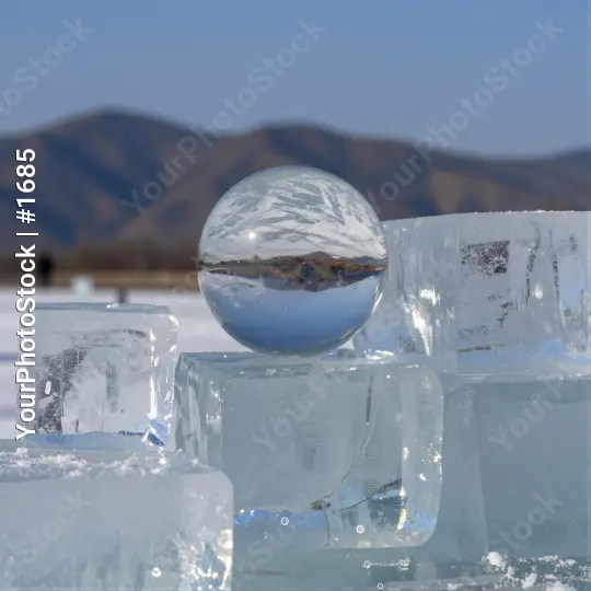 Frozen Lake Ice Cubes Reflecting Sky and Mountains