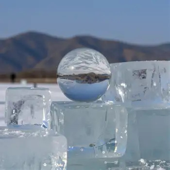 Frozen Lake Ice Cubes Reflecting Sky and Mountains