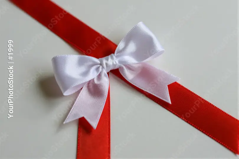 Red Ribbon with White Bow Close-Up tied neatly gift