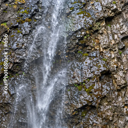 Serene Waterfall Cascading Down Rocky Cliff moss