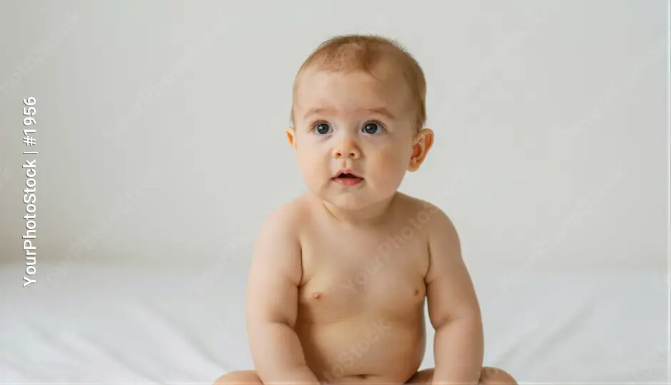 Curious Baby Sitting on White Surface portrait