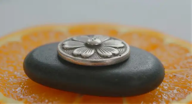 Floral Silver Button on Orange Slice design focal point