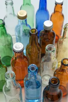 Vintage Glass Bottles on White Surface colorful