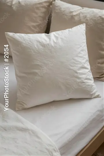 Close-up of neatly arranged square pillows on a bed hotel