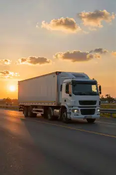 Truck on Road at Sunset trailer empty sky clouds