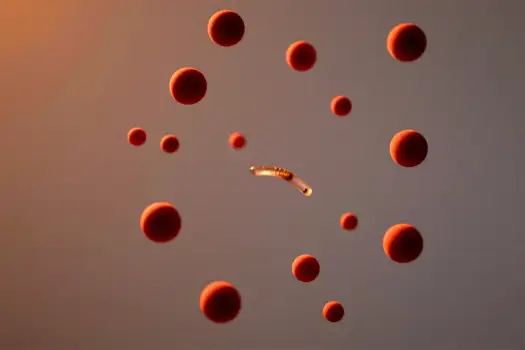Floating Orange Spheres with Worm-Like Object in Surreal Setting