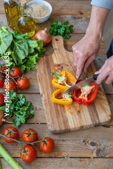 Hands Cutting Bell Pepper on Wooden Board kitchen