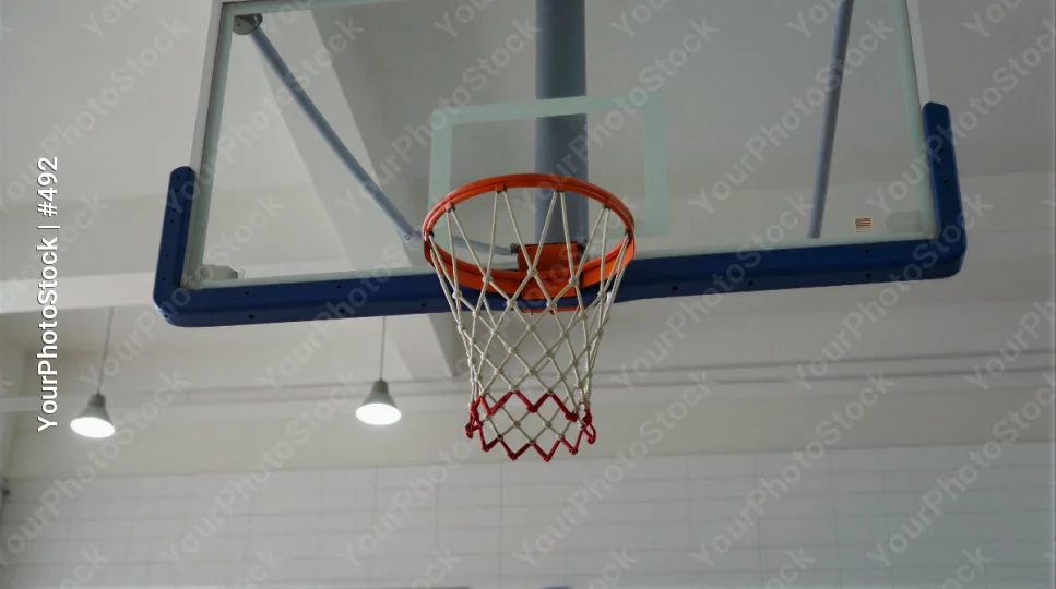 Metal Basketball Hoop Hanging from Ceiling in Gymnasium