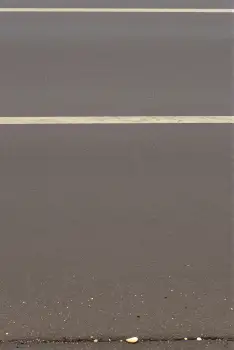 Smooth Grey Surface with Blurred Lines and Dirt concrete parking asphalt