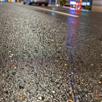 Night Wet Road with Rocks and Blue Line pebbles