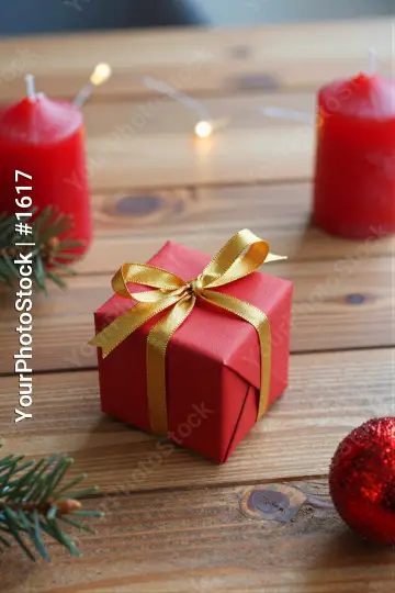 Red Gift Box with Gold Ribbon on Wooden Table