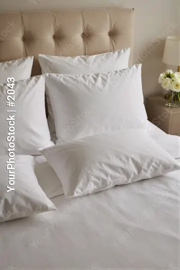 Minimalist Bedroom Setup with White Sheets and Pillows hotel