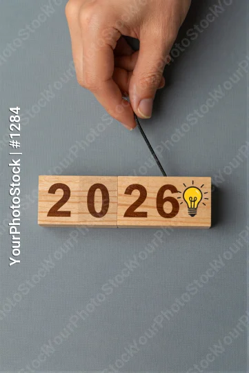 Hand Holding Wooden Block with 2026 Numbers for New Year Concept