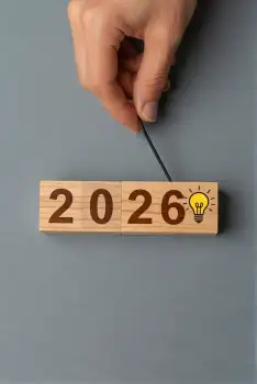Hand Holding Wooden Block with 2026 Numbers for New Year Concept