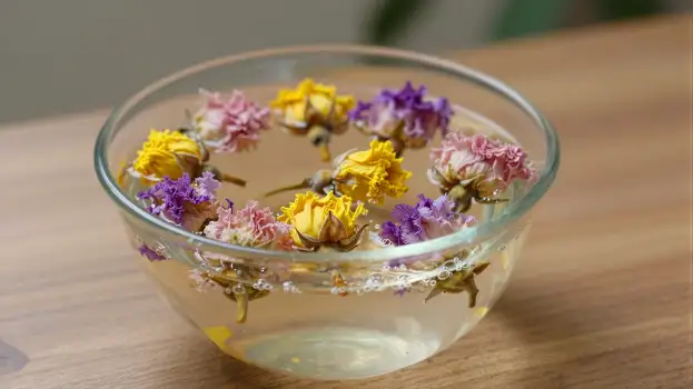 Dried Flowers Floating in Water Bowl on Wood Table