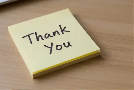 Thank You Sticky Note on Wooden Desk business card