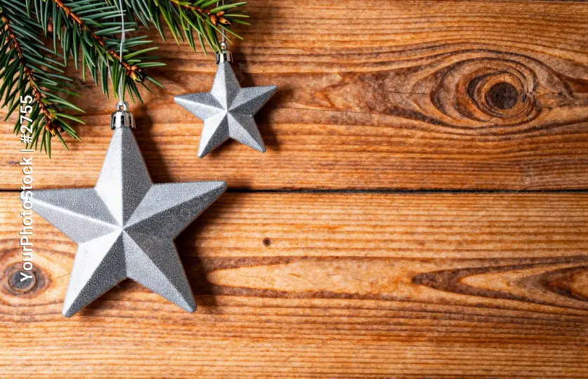Rustic Wooden Background with Evergreen Sprigs and Geometric Stars