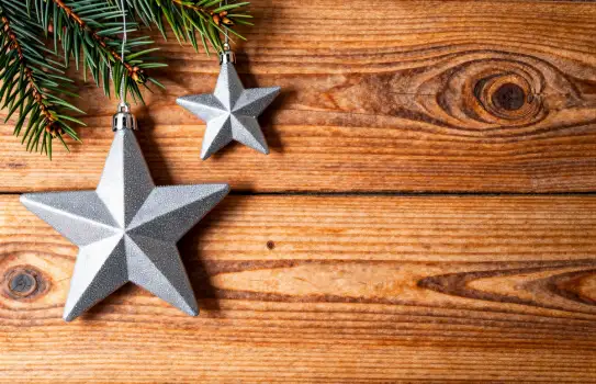 Rustic Wooden Background with Evergreen Sprigs and Geometric Stars