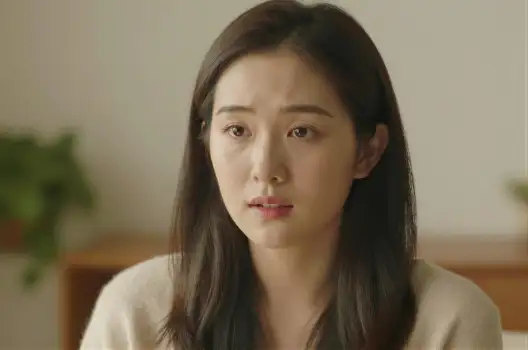 Serious Woman in Beige Blouse Looking Somber late twenties