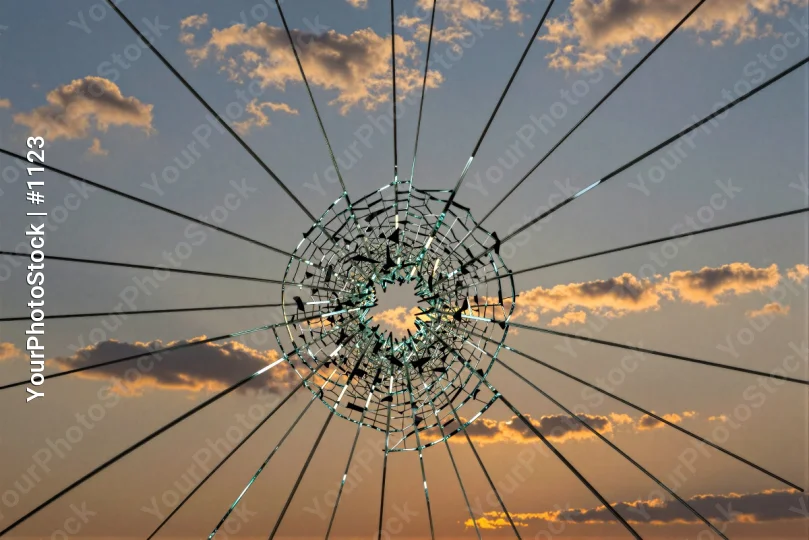 Shattered Glass Window with Radial Wires - Dramatic Sunset