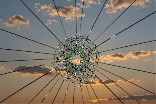 Shattered Glass Window with Radial Wires - Dramatic Sunset