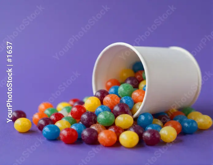 Colorful Jelly Beans Spilling Out of White Cup