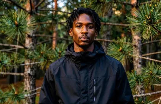 Portrait of a Young Black Man with Natural Hair in an Outdoor Setting