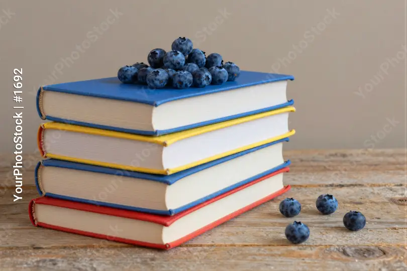Books and Blueberries on Wooden Surface stack