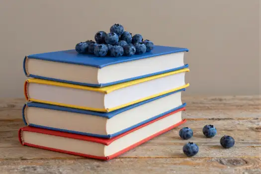 Books and Blueberries on Wooden Surface stack