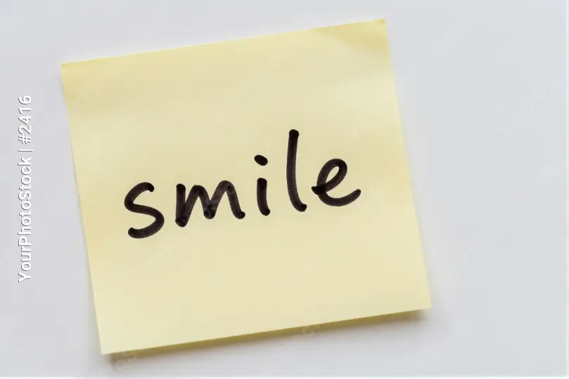 Yellow Sticky Note with Cursive 'Smile' Text cursive smile