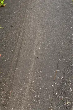Uneven Asphalt Road with Debris scattered urban