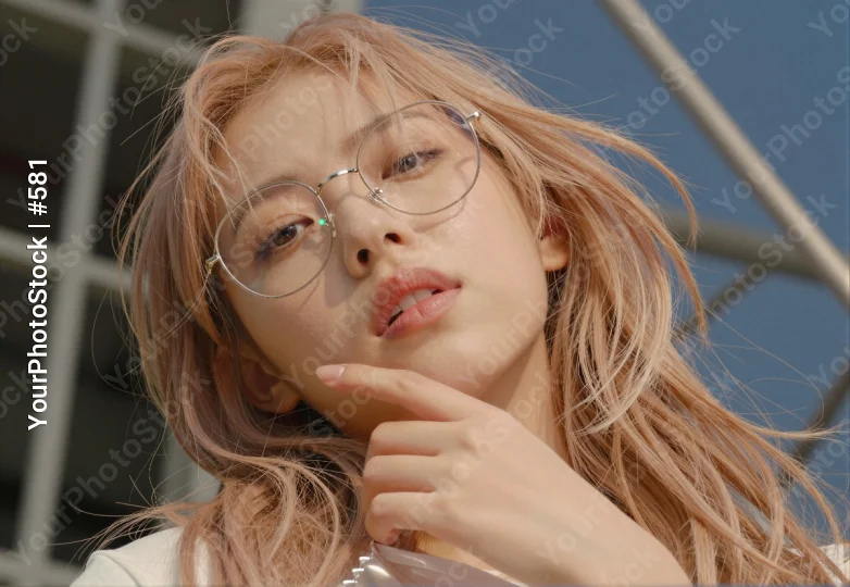 Serious Young Woman with Blonde Hair and Glasses Deep in Thought asian