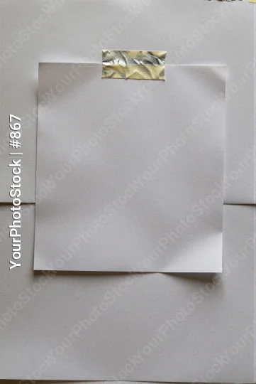 White Paper on Wall with Silver Tape taped blank sticky note