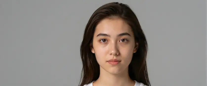 Young woman with long dark hair smiling at camera asian woman