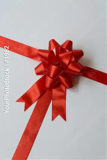 Red Ribbon Bow Close-Up layers neatly tied shiny gift