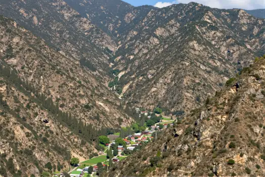 Mountain Landscape with Town rocky peaks green vegetation