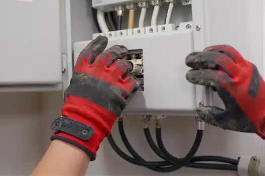 Person Working on Electrical Panel with Screwdriver