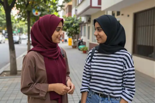 Two young women conversing on a street conversation